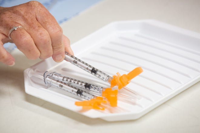 Vials of COVID-19 vaccine were loaded last year during a clinic held by the Shawnee County Health Department. That department on Monday began making the COVID-19 vaccine available to children ages 6 months to 5 years.