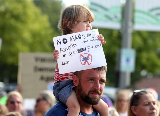 Colin Clements, 35 of Davisburg, Michigan and his son Cameron Clements, 2 were two of over 200 that came to protests the wearing of masks for kids in Oakland County schools in front of the Oakland County Health Department in Pontiac on August 25, 2021.