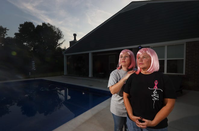 Karen Boyd was diagnosed with breast cancer in April, about a year and a half after her daughter Allison Robertson was diagnosed. Now the duo share tips, facts and struggles in a Facebook group for people affected by the disease. The mother and daughter are seen here in matching  hair from The Pink Wig Project at Boyd's Bartlett home on Tuesday, Aug. 24, 2021.
