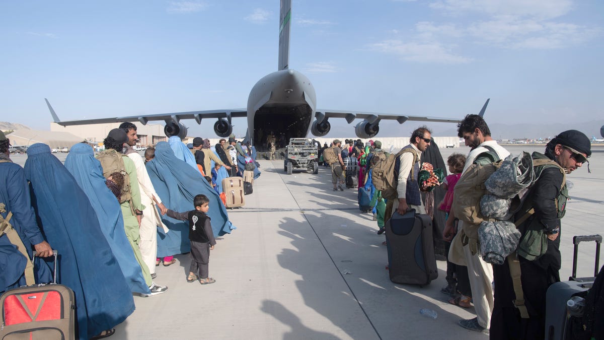 In this image provided by the U.S. Air Force, U.S. Air Force loadmasters and pilots assigned to the 816th Expeditionary Airlift Squadron, load people being evacuated from Afghanistan onto a U.S. Air Force C-17 Globemaster III at Hamid Karzai International Airport in Kabul, Afghanistan, Tuesday, Aug. 24, 2021. 