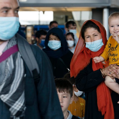 Families evacuated from Kabul, Afghanistan, walk t