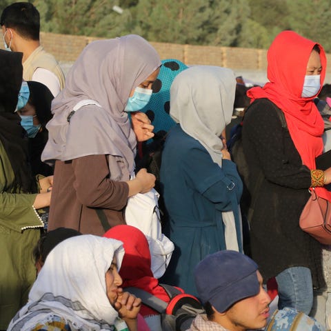 Afghans gather near an evacuation control checkpoi