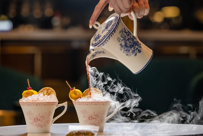 Dry ice adds the steamy visuals to a chilly Tee Time cocktail at The Ray hotel's Lobby Bar in Delray Beach. The drink combines hibiscus tea syrup, fresh lemon juice, plus strawberry and lemongrass-infused vodka, all shaken and poured tableside for two.