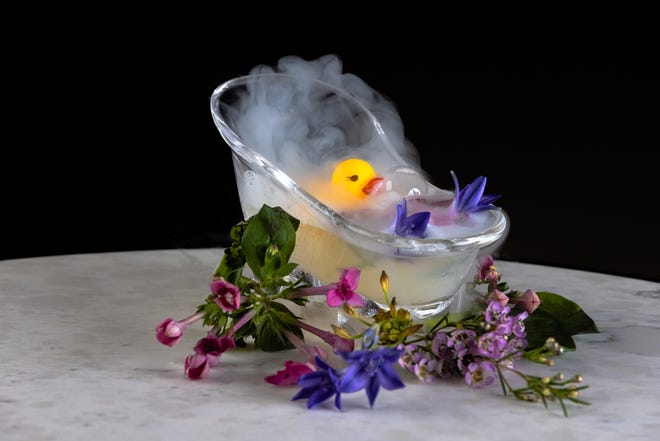 The Hard Day's Work cocktail is served at The Ray hotel's Lobby Bar in Delray Beach. It combines vodka, lemon juice and honey syrup in a mini bathtub.