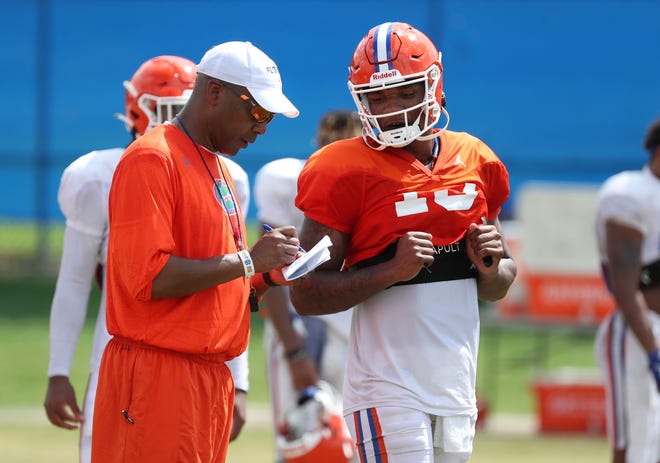 Garrick McGee, left, returns to the sidelines to coach the quarterbacks after serving as an analyst for the Gators in 2020.