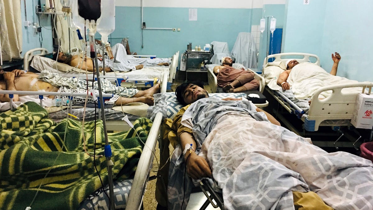 Wounded Afghans lie on a bed at a hospital after an attack on the airport in Kabul, Afghanistan, on Aug. 26.