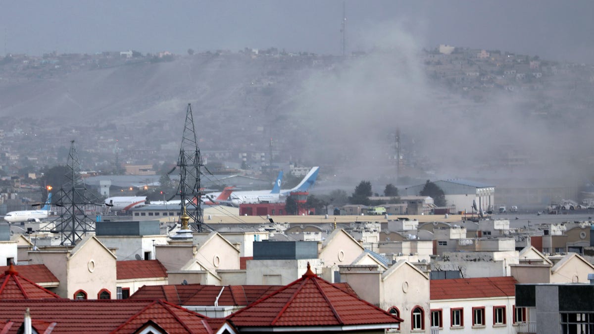 Smoke rises from explosion outside the airport in Kabul, Afghanistan, Thursday, Aug. 26, 2021. The explosion went off outside Kabul's airport, where thousands of people have flocked as they try to flee the Taliban takeover of Afghanistan.