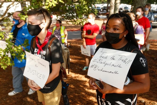 Demonstrators protest banning Critical Race Theory in the classroom in front of Brumby Hall on the campus of the University of Georgia in Athens on Friday. Brumby Hall was the site of Linnentown, a Black community that was forced out of their home via an urban renewal project lead by UGA and the City of Athens.