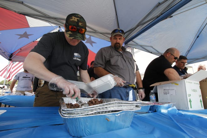 From left, Early police Sgt. Steven Means, sheriff's investigator Leighton Wyatt, Early Director of Public Works Nathan Land and Early Police Chief David Mercer help serve brisket plate lunches.