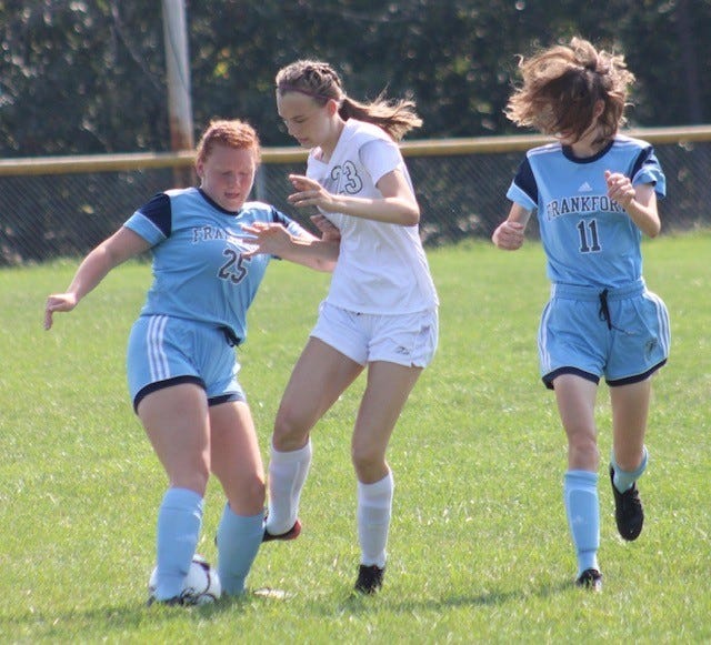 Frankfort's Veronica VanMeter (25) and Erin Clark (11)  battle for the ball against Bishop Walsh.