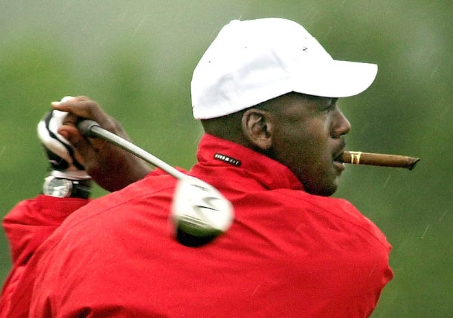 Michael Jordan loosens up on the practice tee in a steady rain at the Mellon Mario Lemieux Celebrity Invitational at the Club at Nevillewood in Presto, Pennsylvania, on June 6, 2002.
