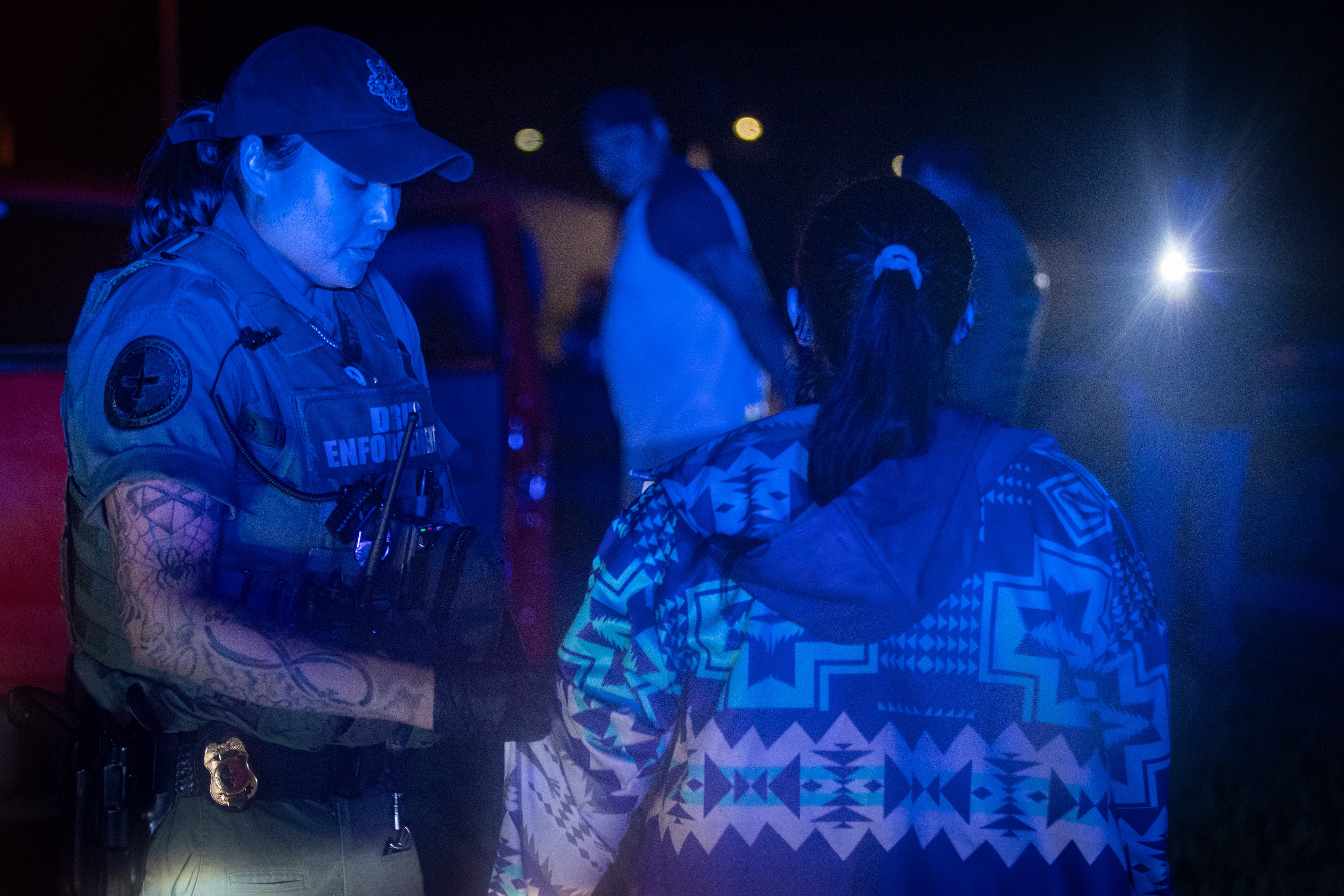 MHA Drug Enforcement patrol agent and K9 handler, Britney Larvie, left, questions a resident during a June traffic stop in Parshall, North Dakota.