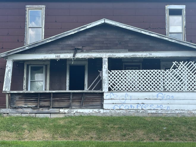 A vacant home located on Park Street in Marion that is currently under ownership of the Marion County Land Bank. A closer look reveals the front porch is beginning to cave in with graffiti spray painted on the front.