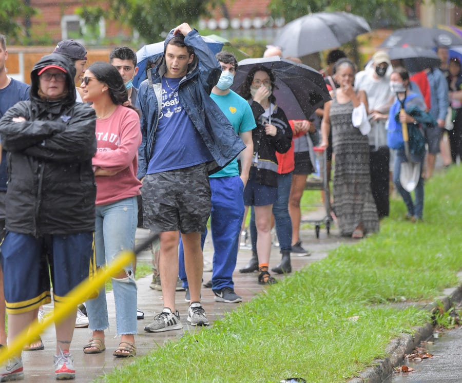People stand in line to pick up sandbags at a city run sandbag distribution location at the Dryades YMCA in anticipation of Hurricane Ida in New Orleans, La., Friday, Aug. 27, 2021.