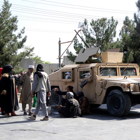 Taliban fighters guard outside the airport in Kabu