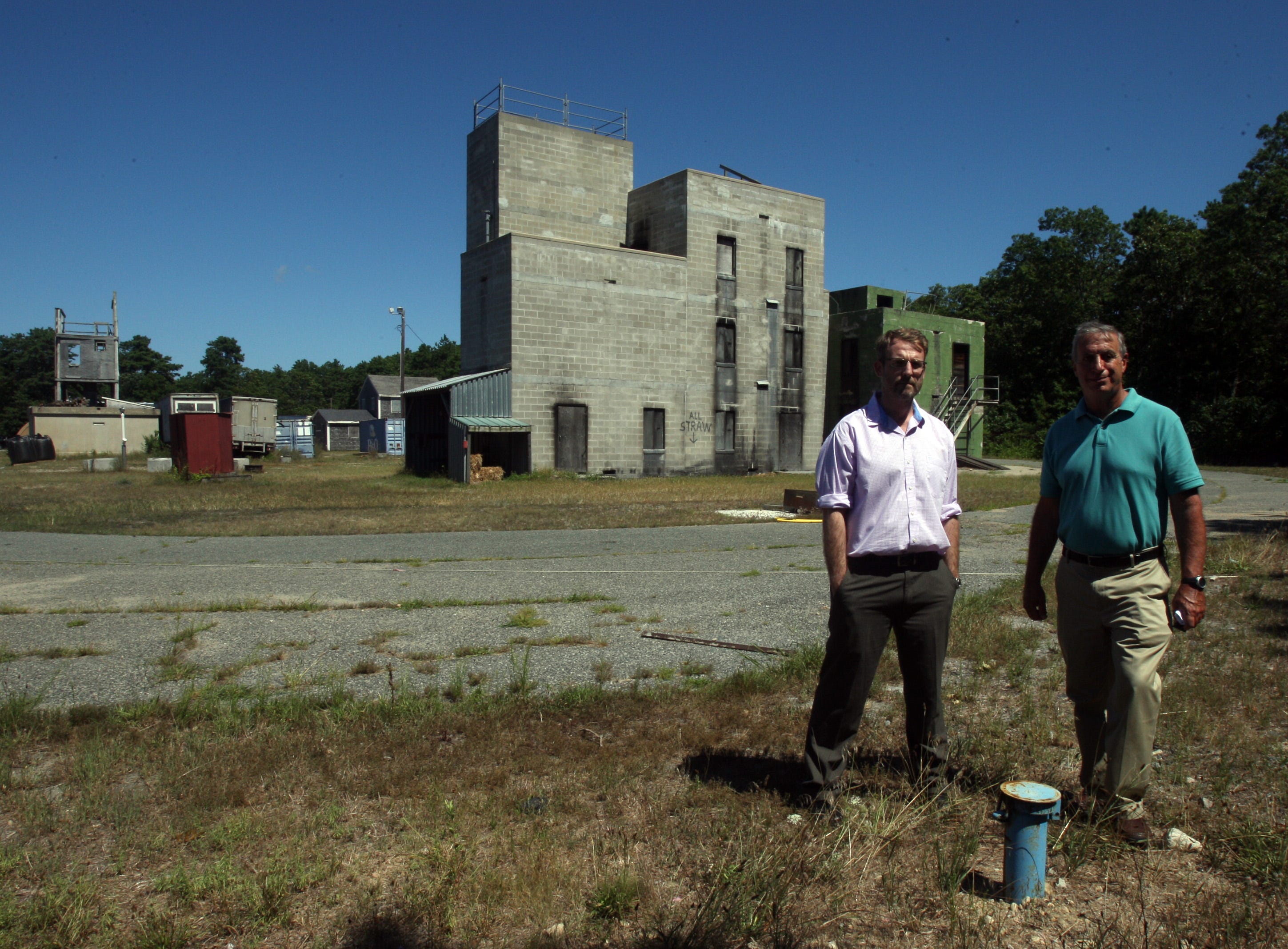 Stephen Tebo, now special assets manager in the Barnstable County Commission, and Tom Cambareri, now a hydrogeologic consultant for the town of Barnstable, stand in 2016 at the southwest corner of the now-closed Barnstable County Fire and Rescue Training Academy over an area planned for soil extraction.