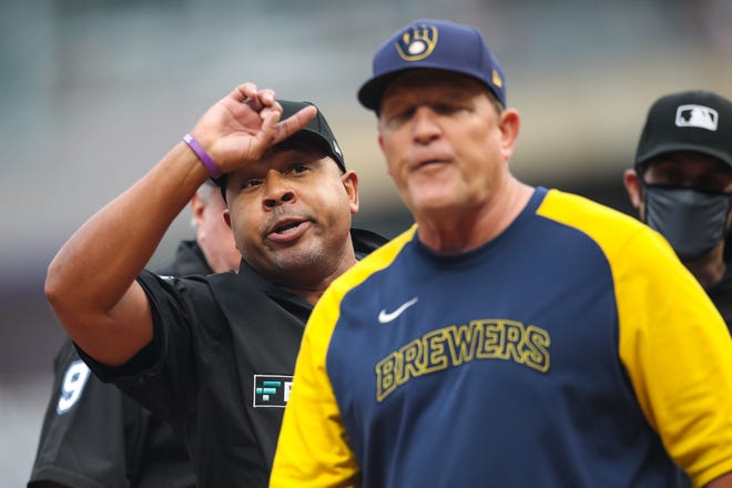 Milwaukee Brewers bench coach Pat Murphy reacts to umpire Adrian Johnson after exchanging lineups with the Minnesota Twins before the start of Saturday's game at Target Field. He was ejected after expressing his unhappiness with the performance of the home-plate umpire on Friday night.