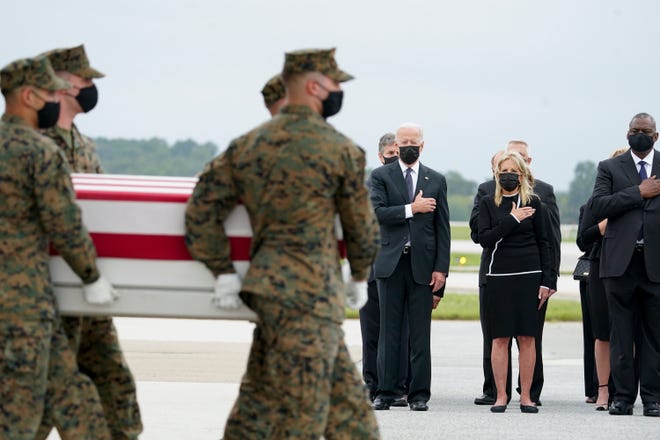President Joe Biden, first lady Jill Biden and Secretary of Defense Lloyd Austin watch as a Marine Corps carry team moves a transfer case containing the remains of Marine Corps Sgt. Johanny Rosario Pichardo, 25, of Lawrence, Mass., Sunday, Aug. 29, 2021, at Dover Air Force Base, Del. Biden embarked on a solemn journey to honor and mourn the 13 U.S. troops killed in the suicide attack near the Kabul airport as their remains return to U.S. soil from Afghanistan.