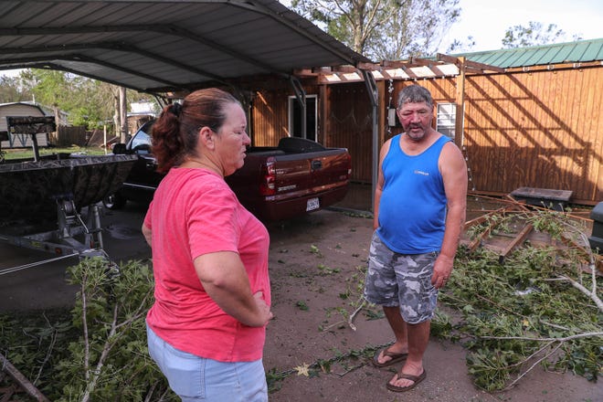 Randy and Eileen Lirette get a first look at their home Monday in Schriever, a day after Hurricane Ida hit. They experienced extensive flooding on their property and damage to their shed and mobile home from fallen trees.