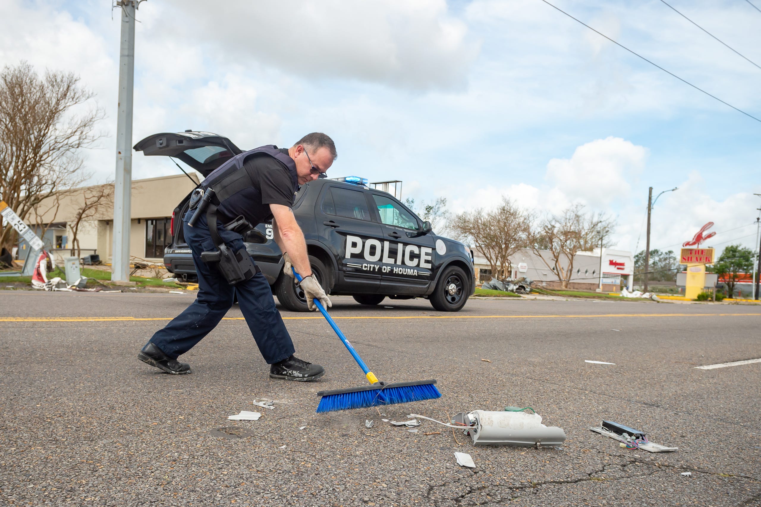 Officer Walter Tenney clearing debris from roadway after Hurricane Ida in Houma, LA. Monday, Aug. 30, 2021.