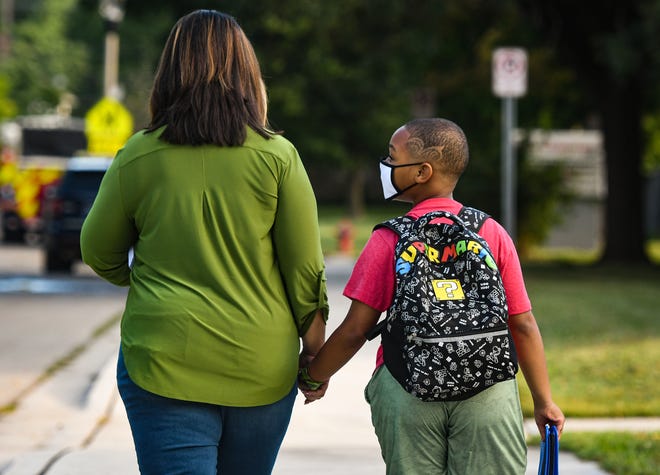 "He's been counting down the days since June," DeLisa Fountain says while walking her son Lynn Jr. Brinkley to his first day of third grade at Riddle Elementary Monday morning, Aug. 30, 2021.