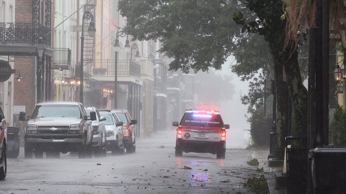 A police car cruises through the French Quarter during Hurricane Ida in New Orleans.