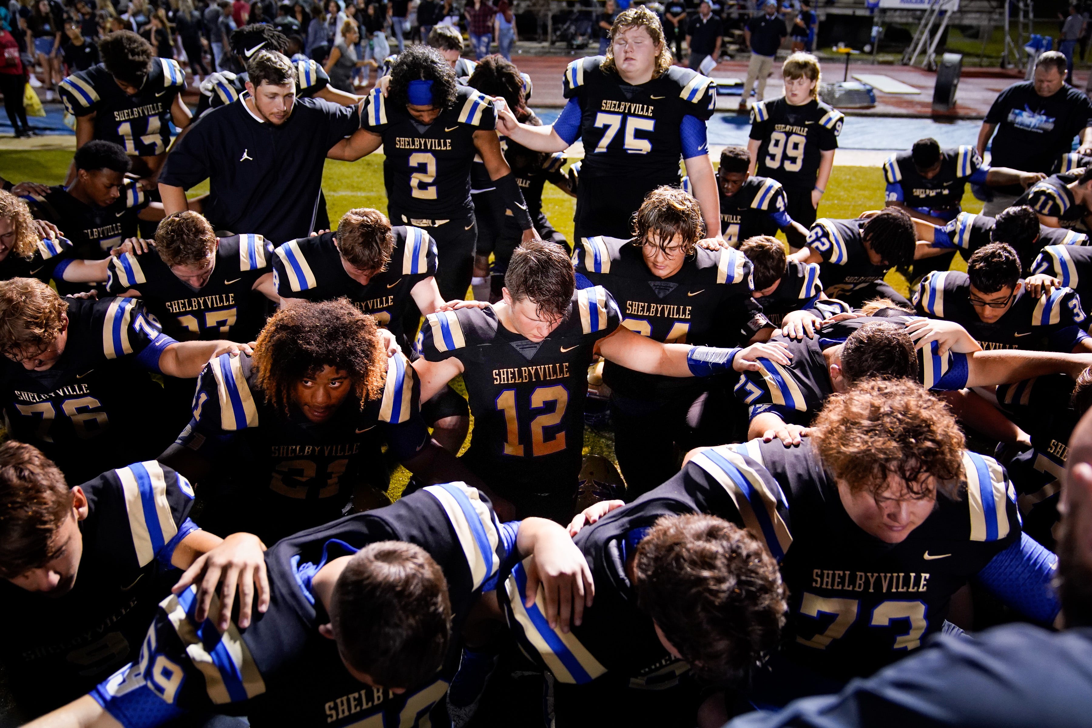 Shelbyville Central's Cayden Puckett (12) huddles with teammates after playing a game against Tullahoma at Shelbyville Central High School in Shelbyville, Tenn., Thursday, Aug. 19, 2021. Puckett returned to the field for the first time on Thursday, eight months after being diagnosed with COVID-19, and about seven months after learning he had myocarditis.