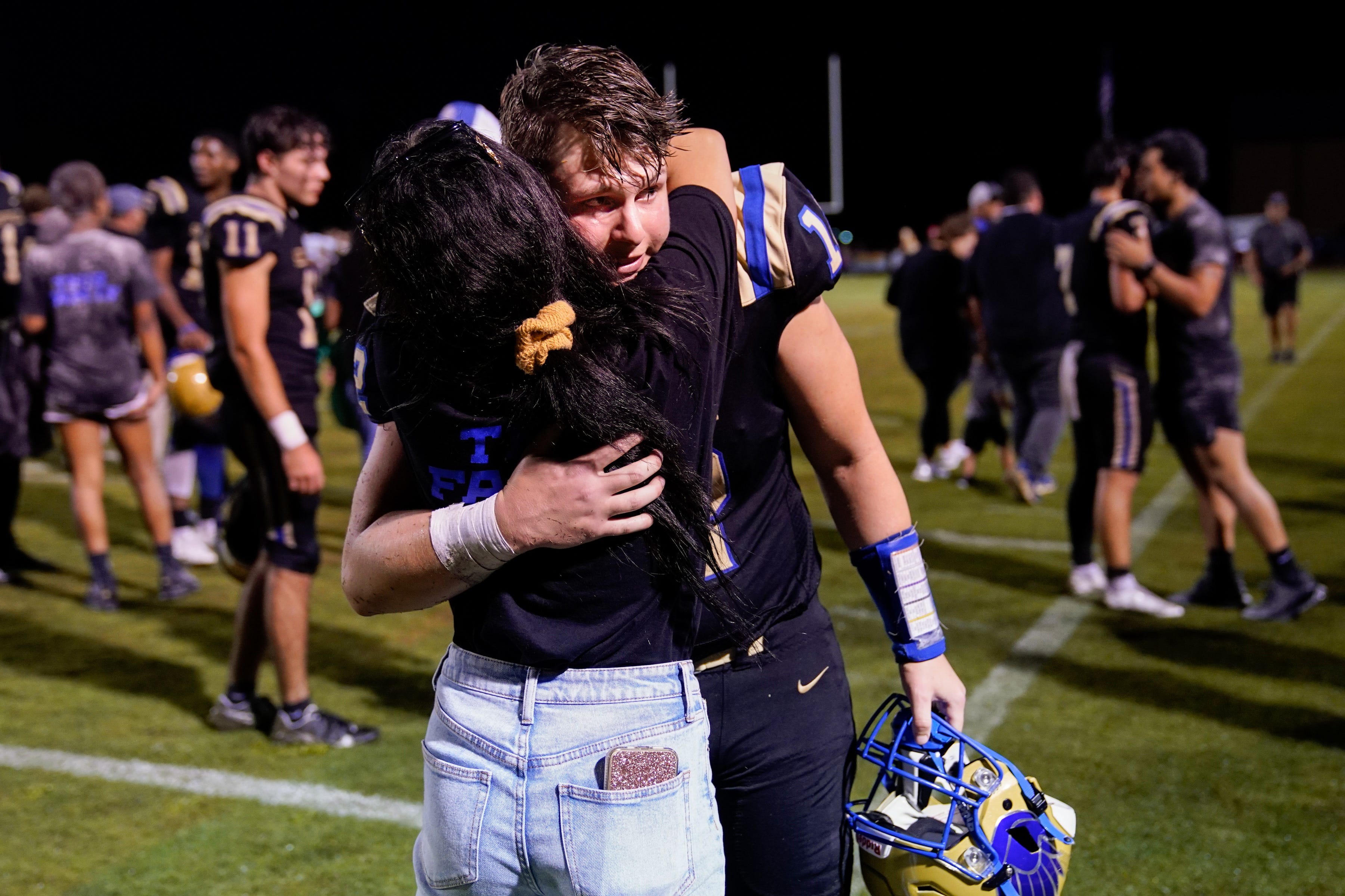 Shelbyville Central's Cayden Puckett (12) greets his girlfriend, Kinley Isbell, after his game against Tullahoma at Shelbyville Central High School in Shelbyville, Tenn., Thursday, Aug. 19, 2021. Puckett returned to the field for the first time on Thursday, eight months after being diagnosed with COVID-19, and about seven months after learning he had myocarditis.