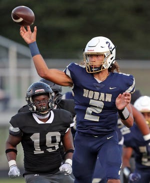 Akron Hoban quarterback Jayvian Crable throws a pass against Bishop Sycamore on Aug. 19. Hoban won 38-0.