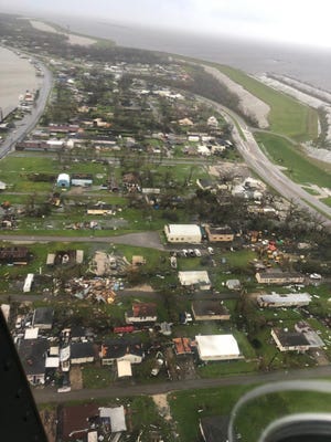 A photo taken Aug. 20, 2021, during a Coast Guard helicopter flight shows damage to homes near Galliano a day after Hurricane Ida swept through the area.