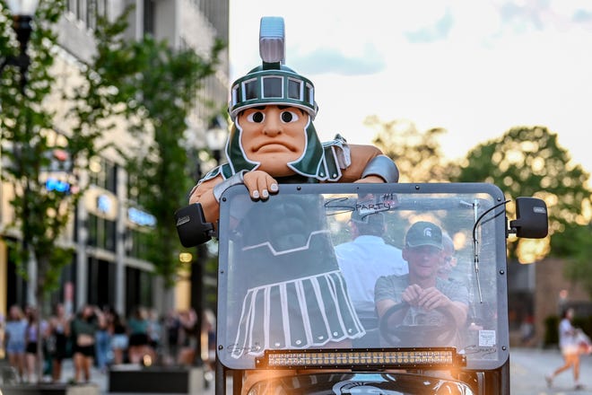 Michigan State University's mascot Sparty rides down Albert Street during the Moonlight ExtravaGRANDza event on Monday, Aug. 30, 2021, in East Lansing.