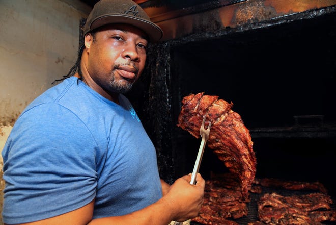 Darnell Ashley at the smoker in his restaurant Ashley’s Bar-B-Que at 1501 W. Center Street. Ashley this year opened a second restaurant, Q, at 2730 N. King Drive, that has table service and drinks.