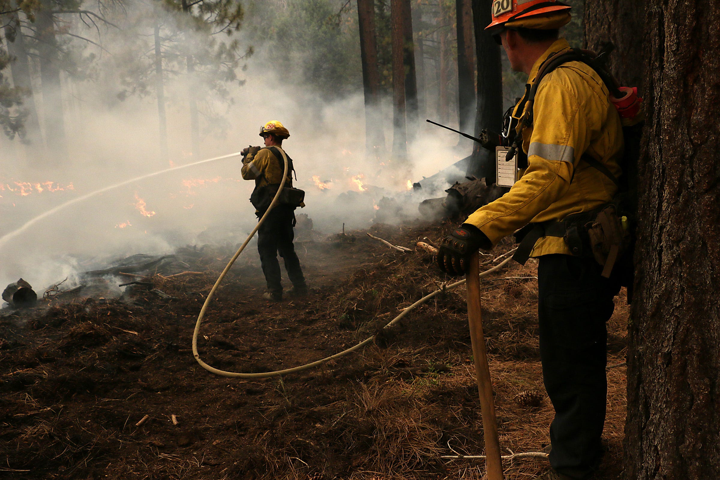 Firefighters with the Los Angeles County Fire Department work to put out the Caldor Fire in the Christmas Valley area of South Lake Tahoe on Aug. 31, 2021.