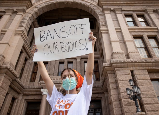 A protester in Austin, Texas participates in a protest against the six-week abortion ban at the Texas Capitol on Wednesday. Dozens of people protested the abortion restriction law that went into effect Wednesday.