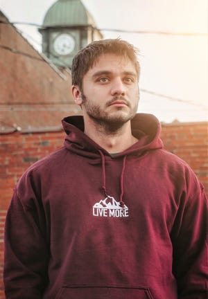 Bronson Allison outside the recently renovated clock tower in Millersburg.