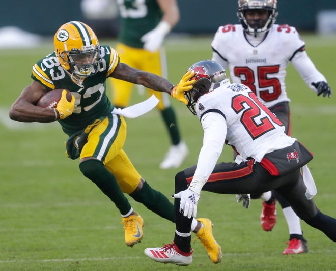 Packers wide receiver Marquez Valdes-Scantling (83) against Tampa Bay Buccaneers defensive back Andrew Adams (26) during the NFC Championship game Jan. 24, 2021, at Lambeau Field.