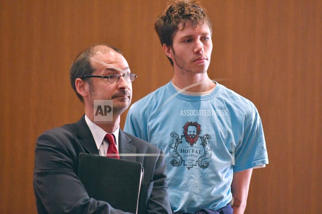 Orion Krause, right, stands with his attorney Edward Wayland, left, at Krause's arraignment in Ayer District Court, in Ayer, Mass., on Monday, Sept. 11, 2017. Prosecutors say 26-year-old Krause, of Rockport, Maine, was sentenced Wednesday, Sept. 1, 2021, to life in prison with the possibility of parole after 25 years after pleading guilty to four counts of second-degree murder in the deaths of his mother, grandparents, and his grandparents' caretaker in 2017.