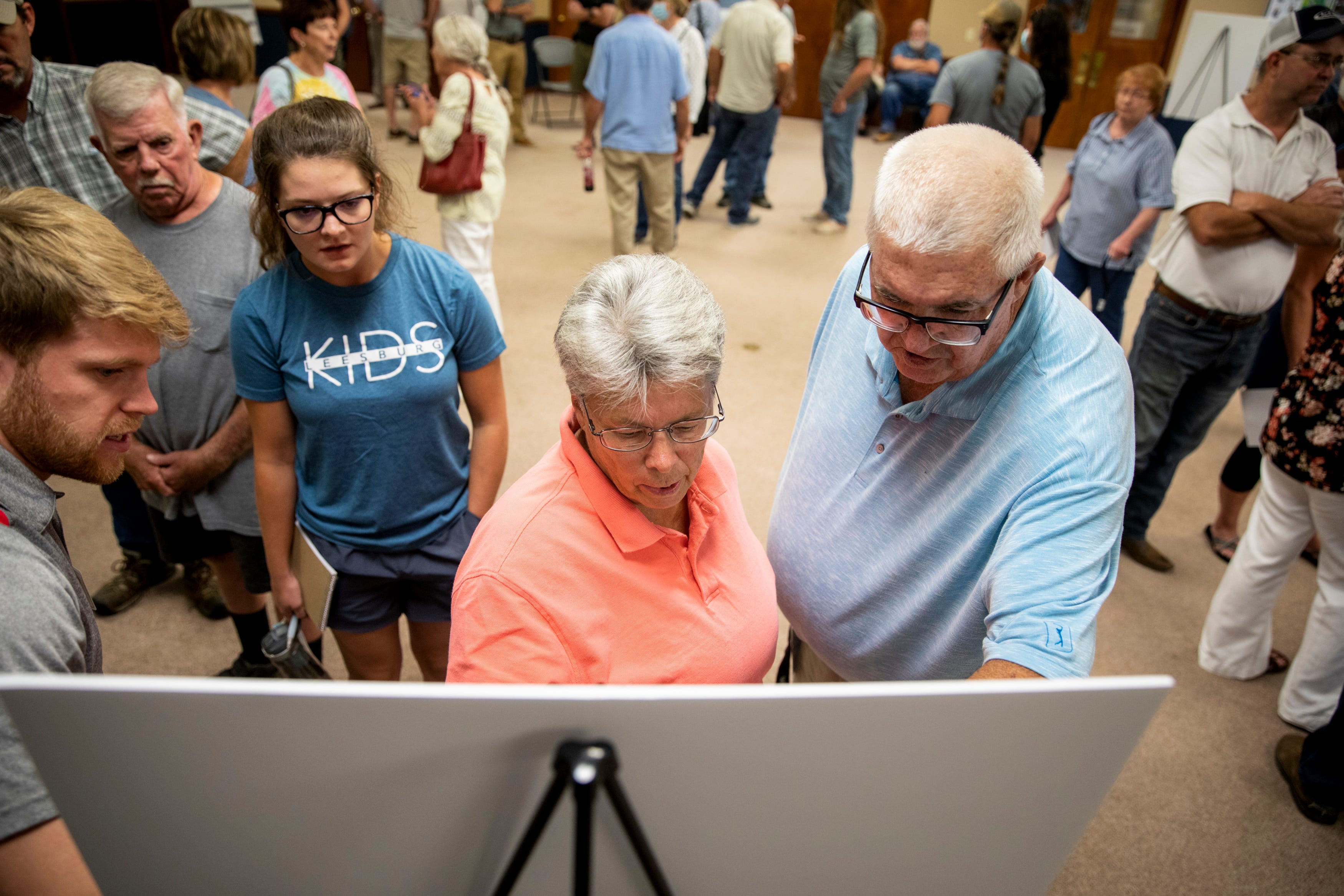 Pam McCauley shows reporter Lee Kendall of The Cynthiana Democrat where her farm is on a map for a proposed solar facility during a Recurrent Energy information session at the Harrison County Cooperative Extension Office in Cynthiana, Ky., on Wednesday, August 25, 2021. 