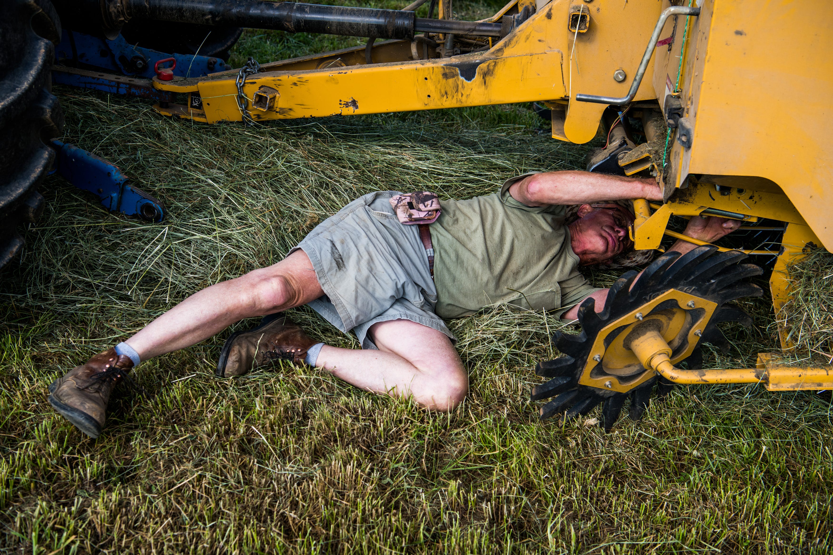 Wayne Clifford, 71, bales hay at his farm on Ruddles Mill Road in Harrison County, Ky. on Saturday, June 5, 2021. 