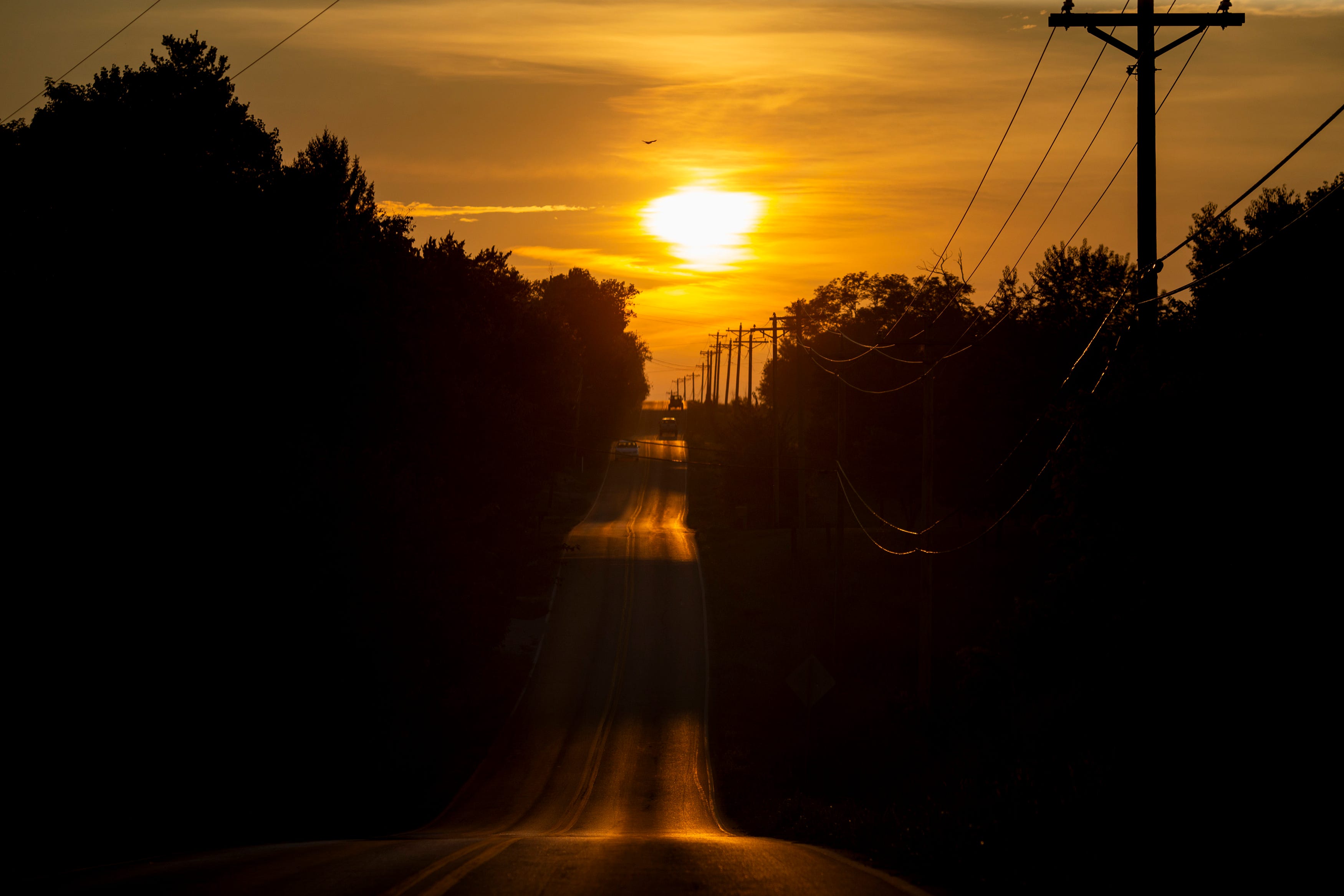 Vehicles travel in Harrison County, Ky., as the sun sets on Wednesday, August 25, 2021. 