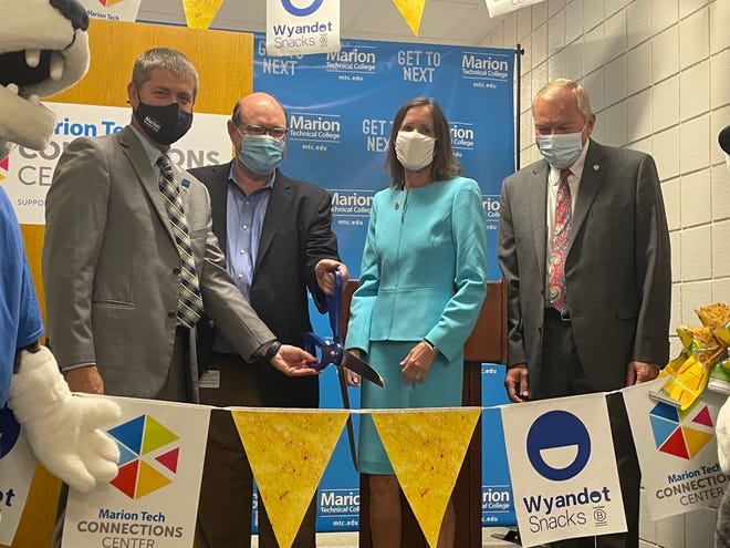 (From left to right): Ryan McCall, president of Marion Technical College; Robert Sarlls, president and CEO of Wyandot Snacks;	Rep. Tracy Richardson; and State Senator Bill Reineke prepare to cut the ribbon to officially open the Connections Center at MTC.