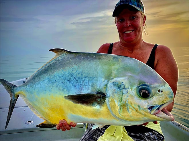 Angela with a nice permit on her last day visiting from Ohio, with Capt. Christian Sommer.