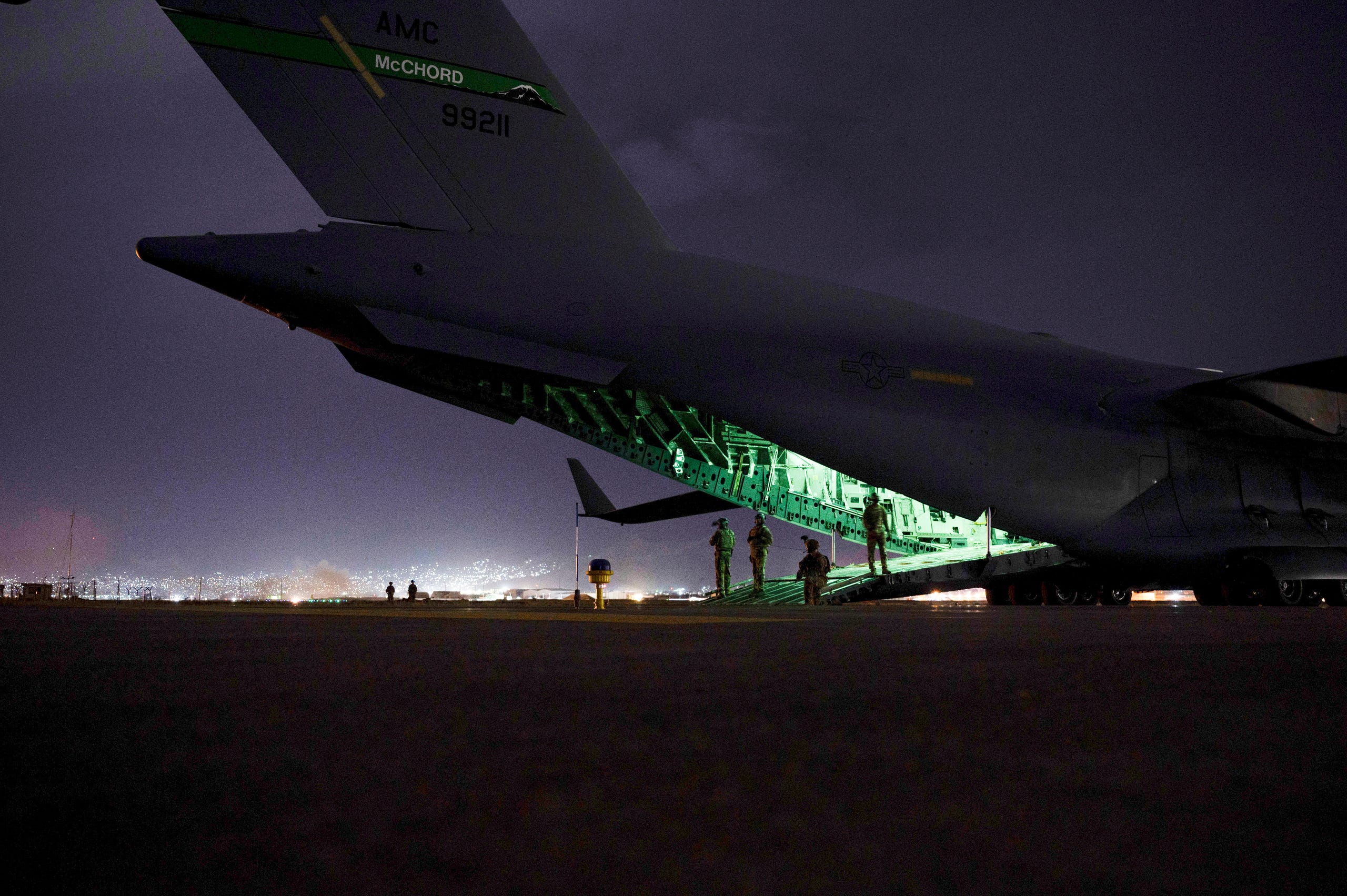 In this Aug. 30, 2021, photo provided by the U.S. Air Force, a Air Force aircrew, assigned to the 816th Expeditionary Airlift Squadron, prepares to receive soldiers, assigned to the 82nd Airborne Division, to board a U.S. Air Force C-17 Globemaster III aircraft in support of the final noncombatant evacuation operation missions at Hamid Karzai International Airport in Kabul Afghanistan.