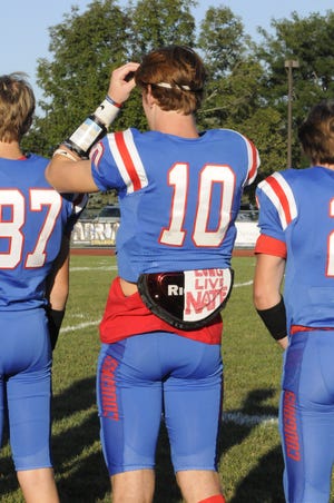 Lenawee Christian's Elliott Addleman has "Long Live Nate" written on his pads. Addleman returned the game's opening kickoff 70 yards for a touchdown. [Telegram photo by Deloris Clark-Osborne]