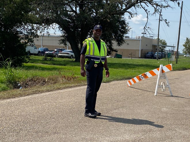 In the aftermath of Hurricane Ida last year, Ascension Parish Sheriff's Office Westside Captain Darryl Smith smiles for a photo while directing traffic at the Frank Sotile Pavilion in Donaldsonville.