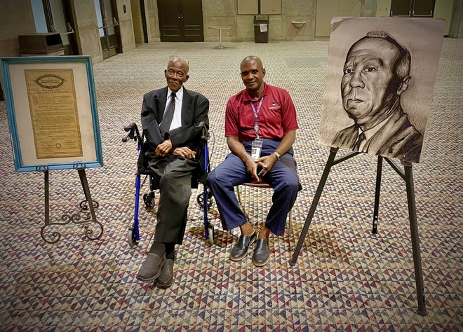 Sollie Mitchell, a former Pullman porter, and Tony Hill sit in the A. Philip Randolph Room at the convention center, next to a document signed by Randolph in 1936 to create the local chapter of the Brotherhood of Sleeping Car Porters.