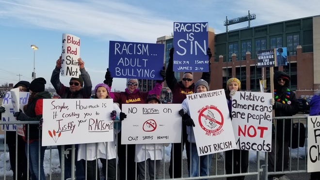 Protestors rally against the use of Native American-based mascots at Lambeau Field in 2018.