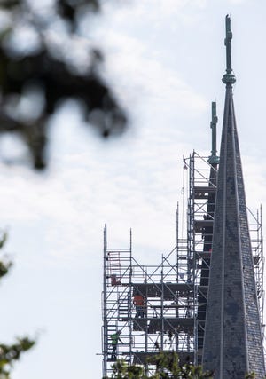 Workers on scaffolding are dwarfed by the twin spires of St. Joseph Catholic Church in Louisville as exterior renovation work continues. Aug. 25, 2021