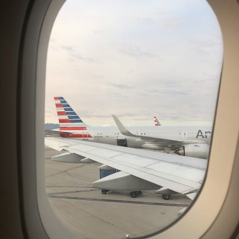 The wing of an American Airlines flight is seen th
