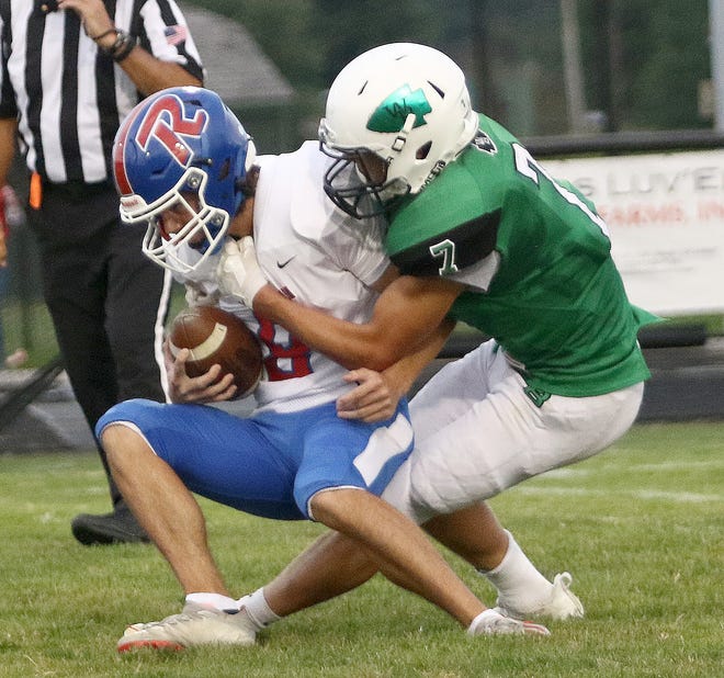 West Branch's Ryan Irwin, right, tackles Revere punter Lawrence Saltis deep in Warrior territory after the snap sailed over Saltis' head during first-half action at West Branch Clinton Heacock Stadium, Friday, September 3, 2021.